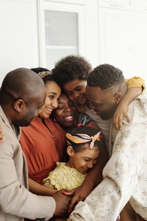 A family leaning into a close group hug