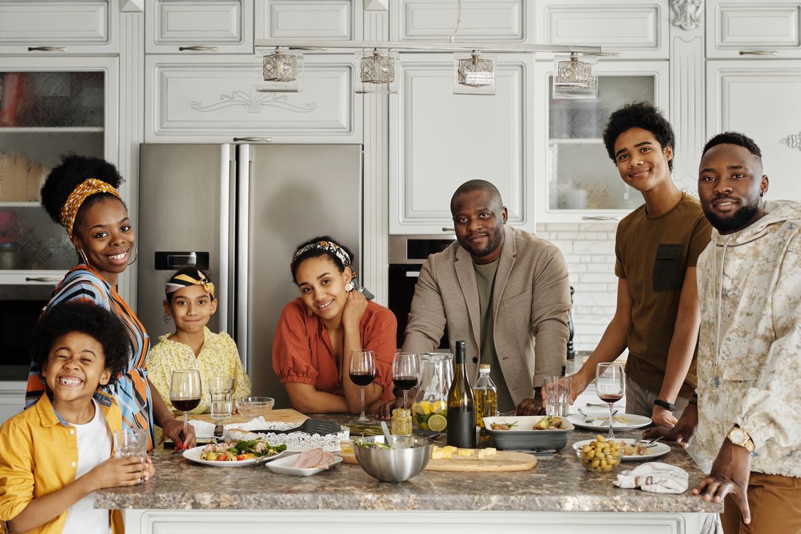 A family sharing a joyful moment around a kitchen table